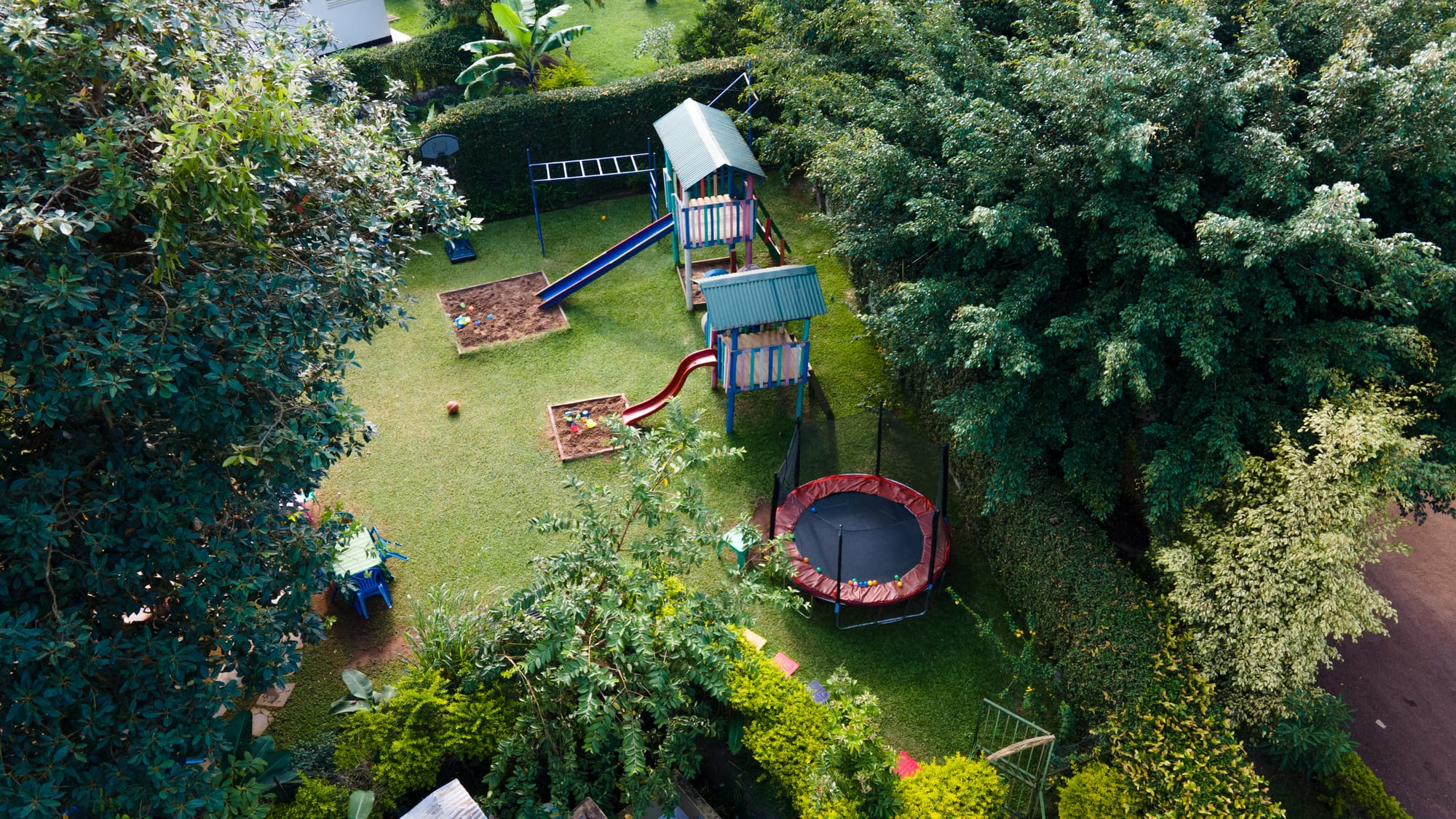Aerial view of the trampoline and climbing frame tucked among the trees