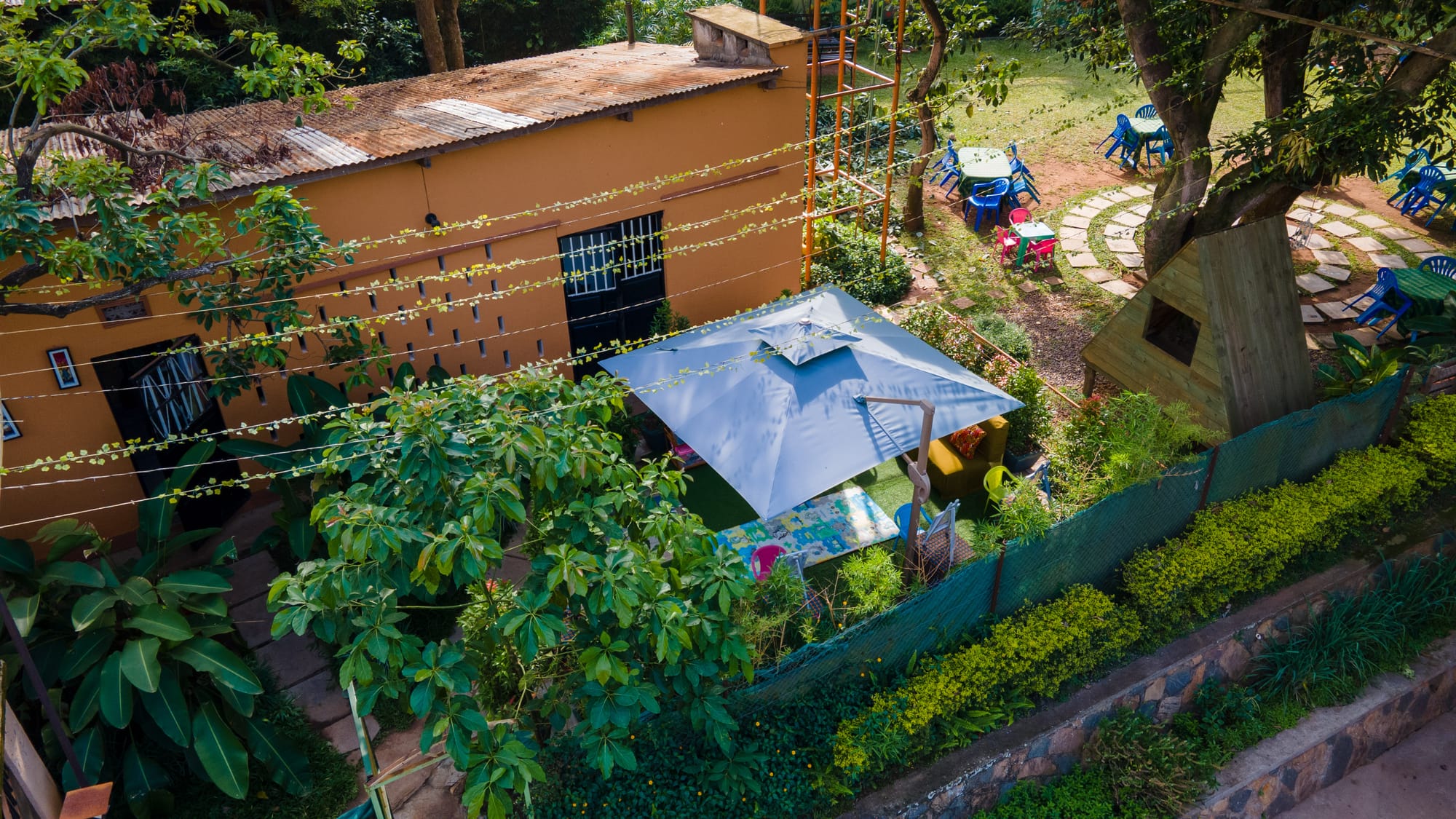 Aerial view of the shaded play area beside the ochre studio building