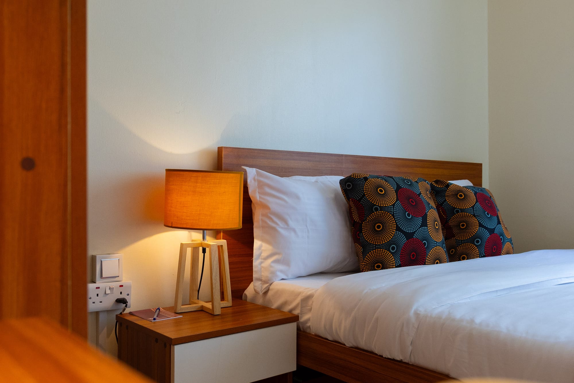 Deluxe Room — the work nook with a tall mirror, shelf and anglepoise lamp