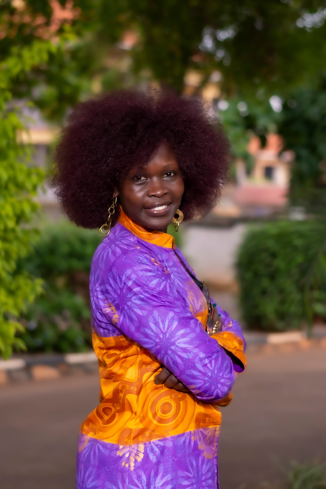 Ashanut Okille, founder of KaraSpace, in a purple and gold African-print dress in the garden