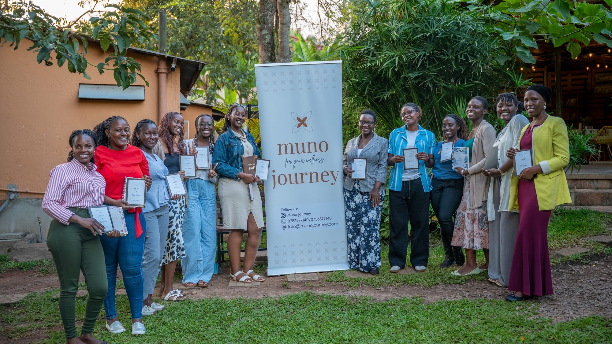 A group gathered by the event banner