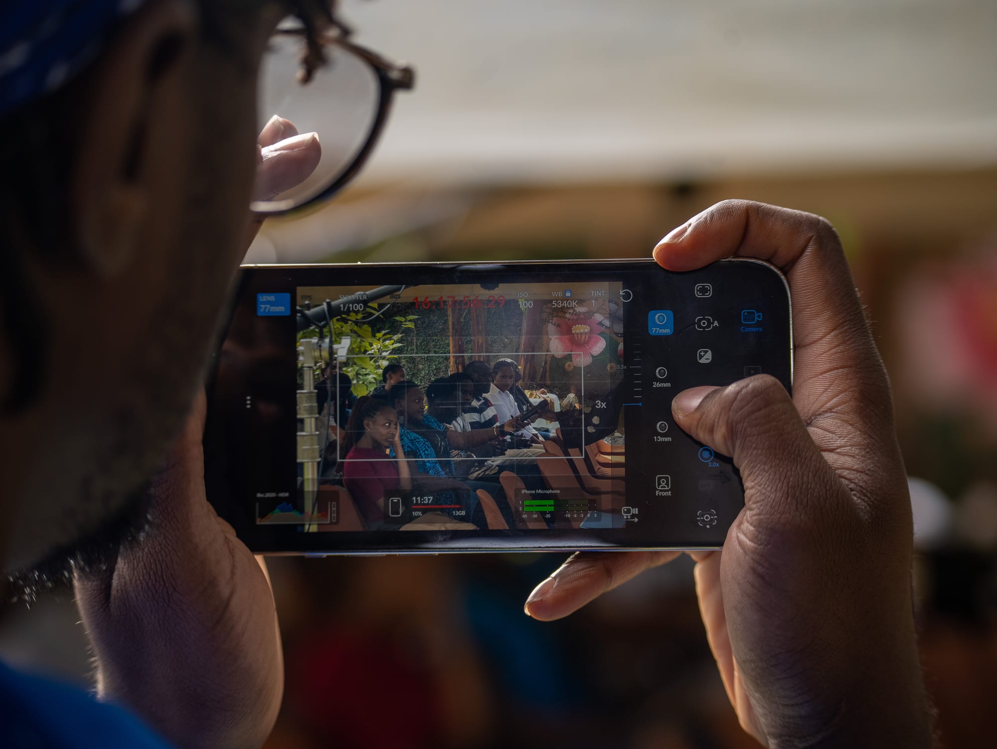 A guest filming the poetry session on a phone