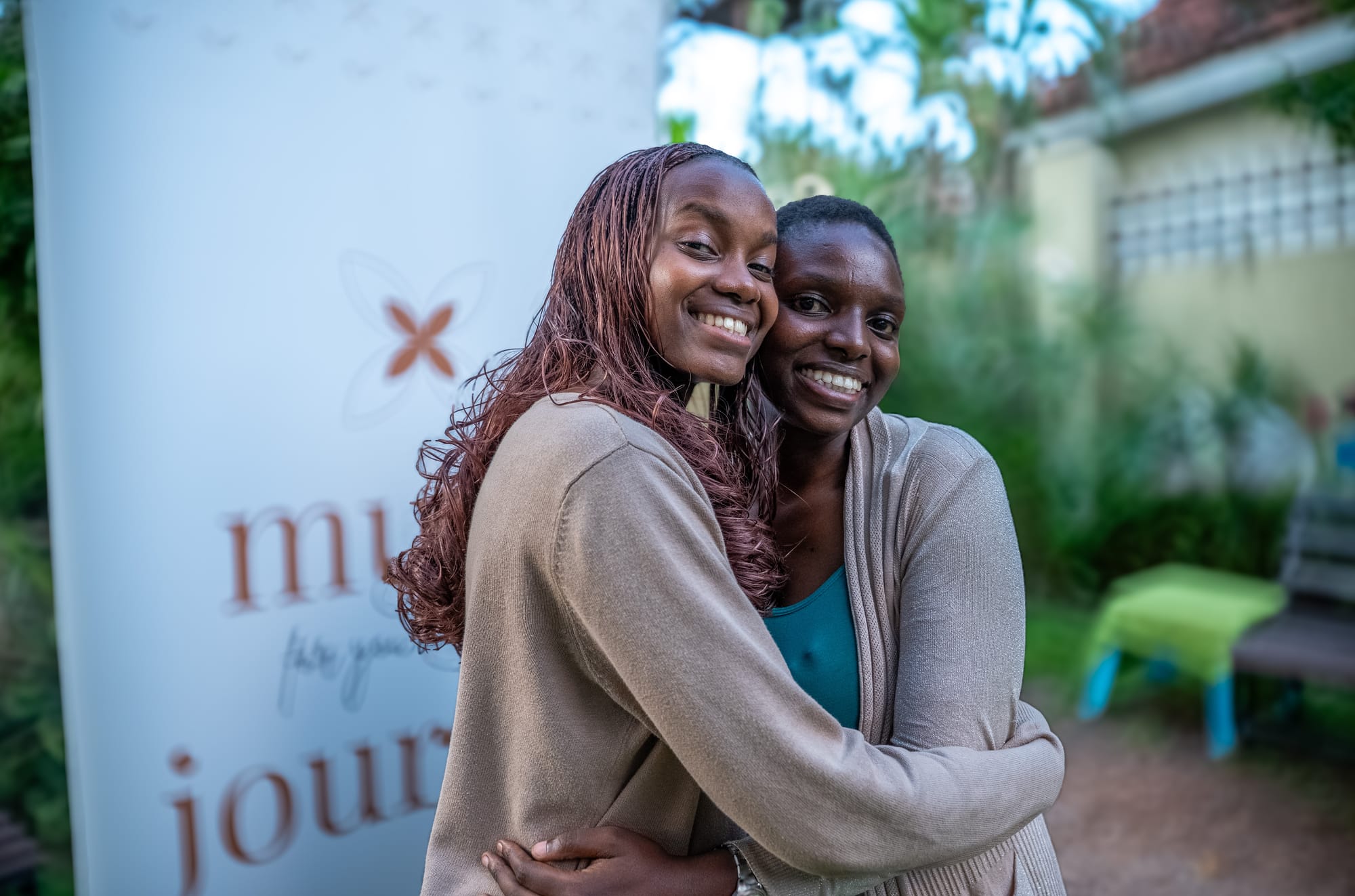 Two friends embracing at a gathering