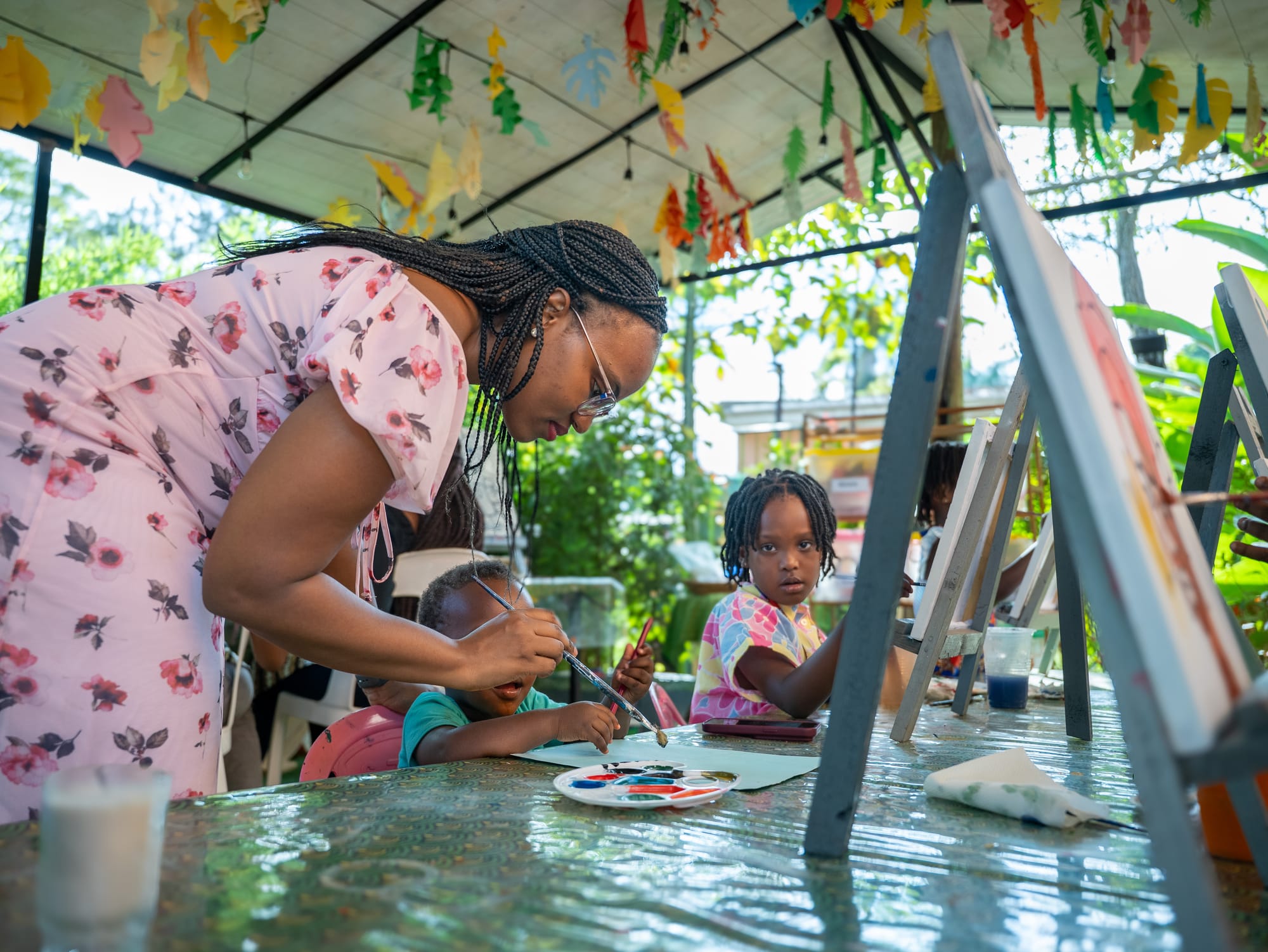 A children's painting session under the garden canopy