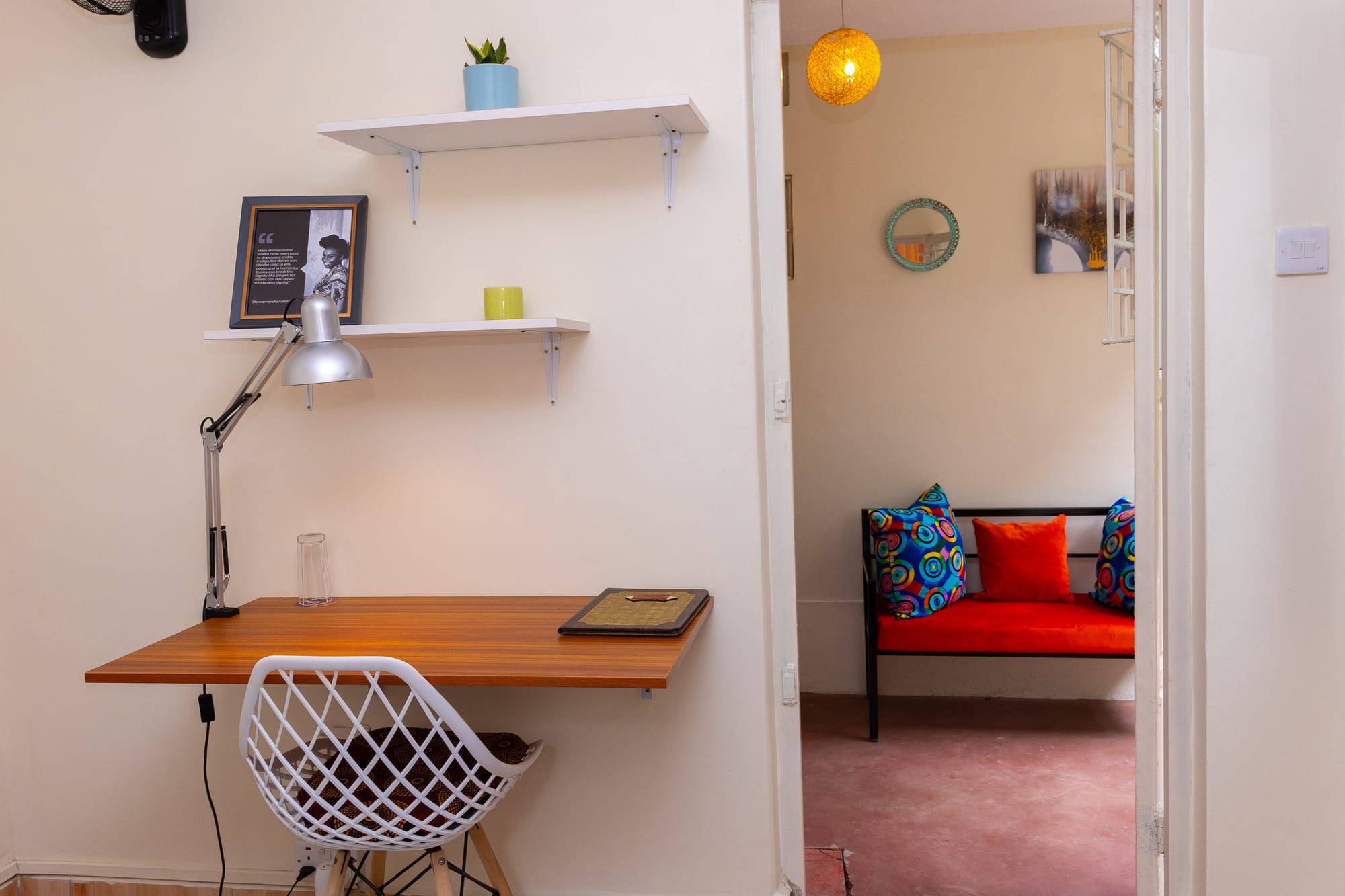 Standard Room — a bright lounge nook with an orange bench and colourful cushions
